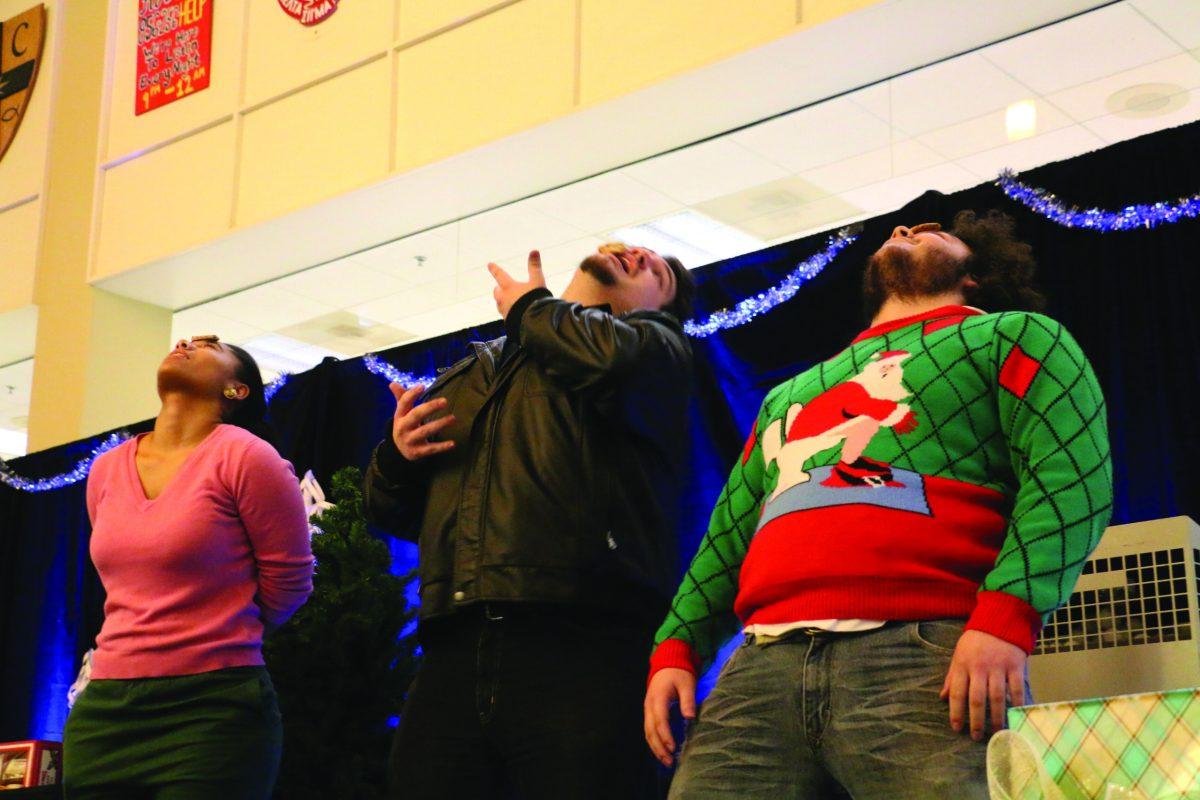 Rowan students compete in a cookie eating competition where the students could not use their hands at the $1000 Holiday Bingo. - Photo Editor/Justin Fata 