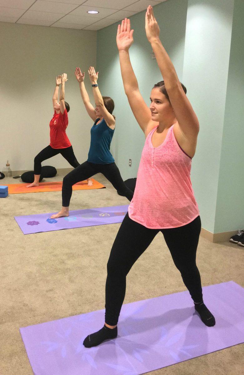 From left: Jennifer Allison, a first year medical student, Patricia Vanston, the associate dean of program and business development, and Courtney Curran, a first year medical student, practice yoga in the new Wellness Center meditation room. -Julia Davis-Vanston for The Whit