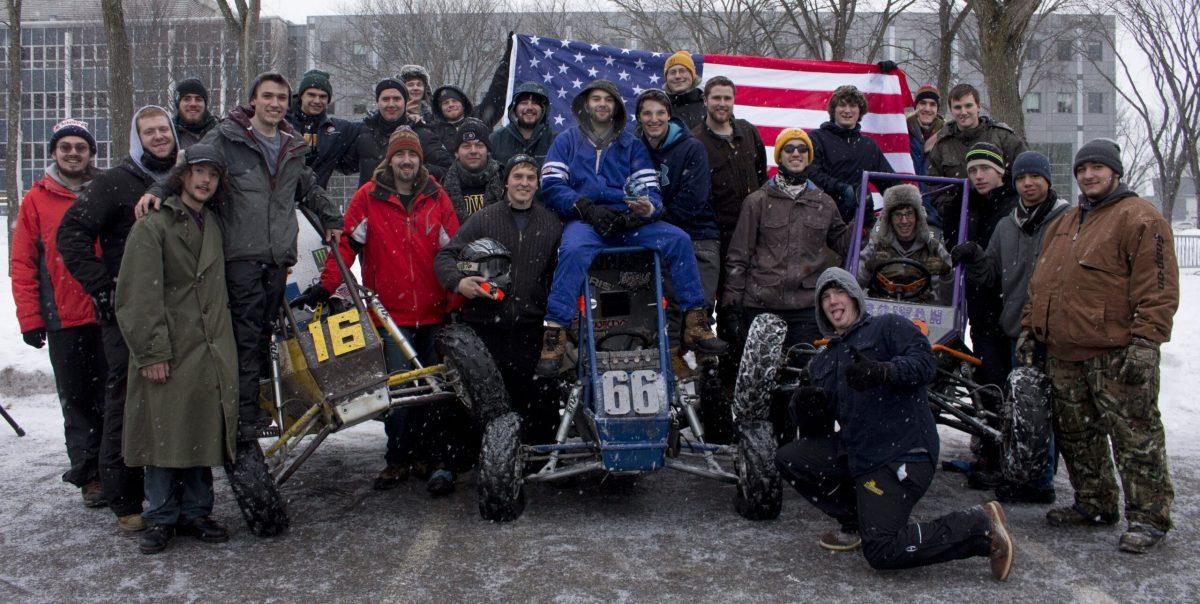 Members of the Society of Automotive Engineers (SAE) club pose with their cars.  SAE is an engineering club that offers students hands-on experience with designing and building race vehicles. -Photo courtesy of Shannon Kagan