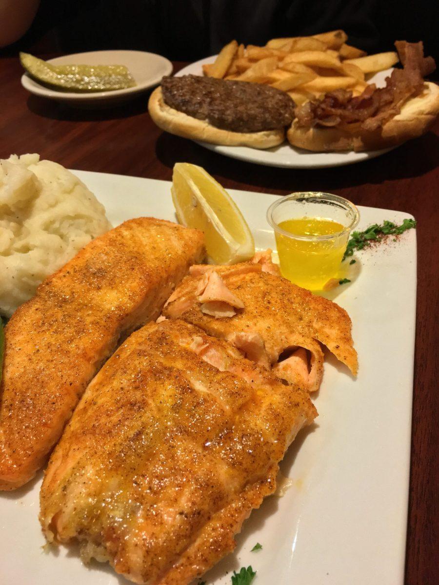 A salmon entree and a bacon cheeseburger from Fireside Family Restaurant. Fireside offers a variety of home-style foods on their menu. -Staff Photo/Jessica Kovalick