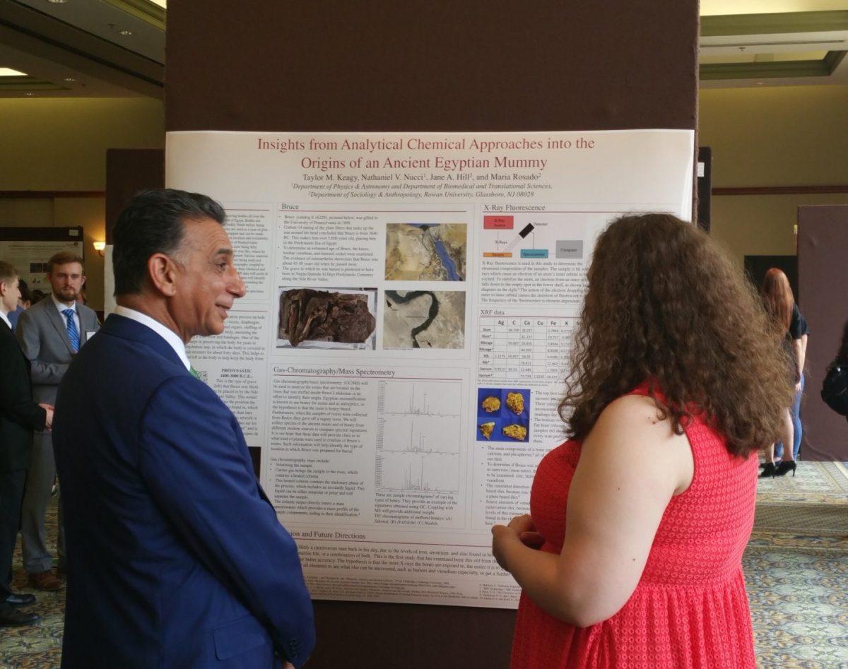 President Ali Houshmand (left) listens to the presentation of Taylor Keagy (right), a junior biochemistry major. 