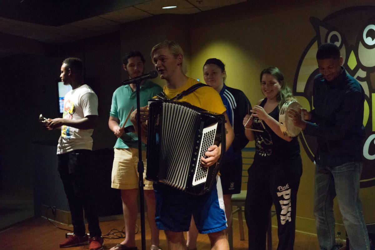 Opera singing major Steve Solkela performing on stage with members of the audience at Prof's Spotlight last Labor Day. Prof's Spotlight is an event in the Chamberlain Student Center that highlights the various student performers of Rowan. -Photo Editor/Cole Ditzel