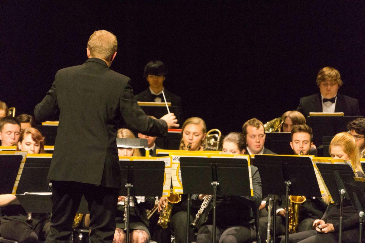 Joseph Higgins conducting Rowan's concert band through one of their many pieces. This concert marked one of few times that Rowan's Concert Band and the Atlantic Brass Band could share the stage. -Photo Editor/Cole Ditzel