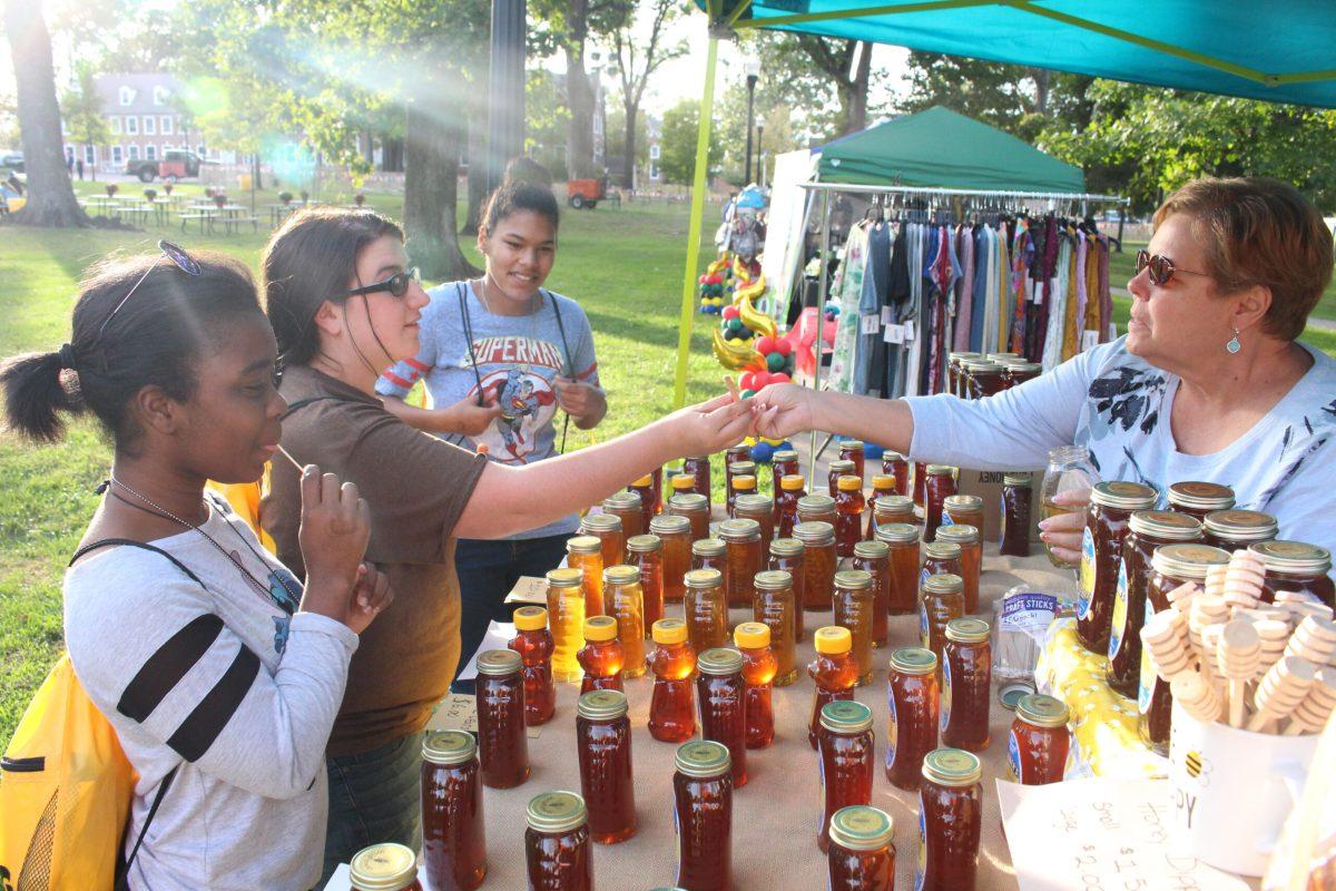 Students getting some homemade honey from one of the stands at the Homecoming Block Party. Other events there included a variety of face painting, outdoor and music themed activities. Photo Credit/Kayla Vitulano