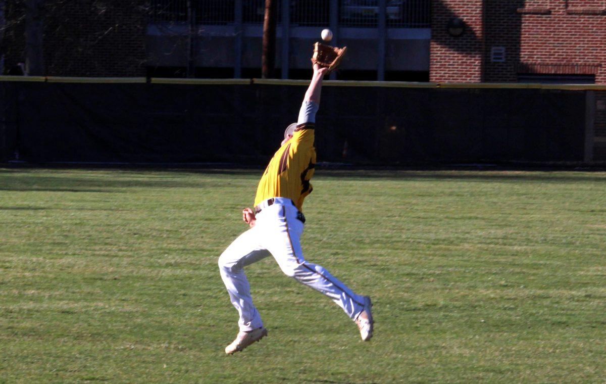 Senior Jason Clapper extends to make a catch earlier this year. Against Haverford, clapper had two runs. -Photo Editor/Amanda Palma