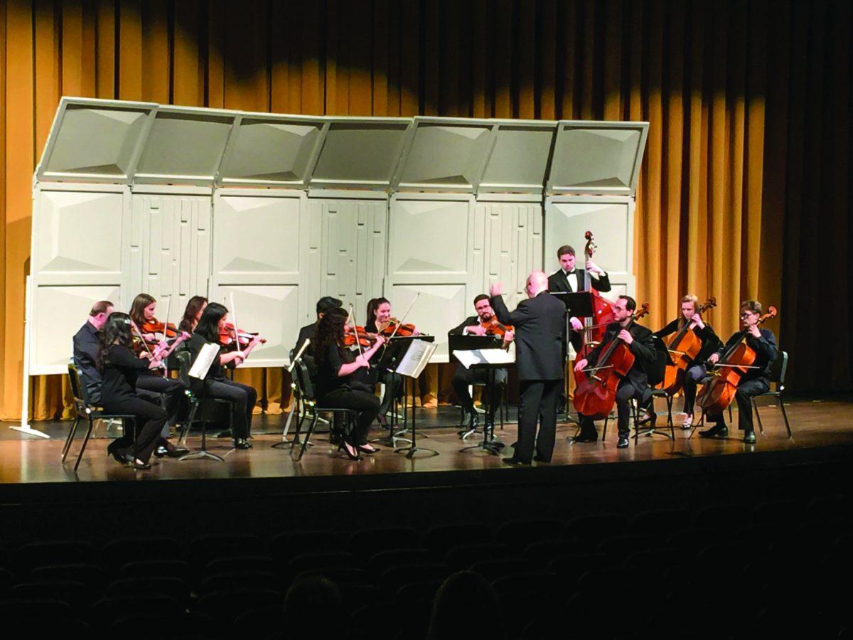 Conductor George Atanasiu leading the Rowan String Ensemble on stage. This was their final performance of the year. Staff Photo/Ellie Leick