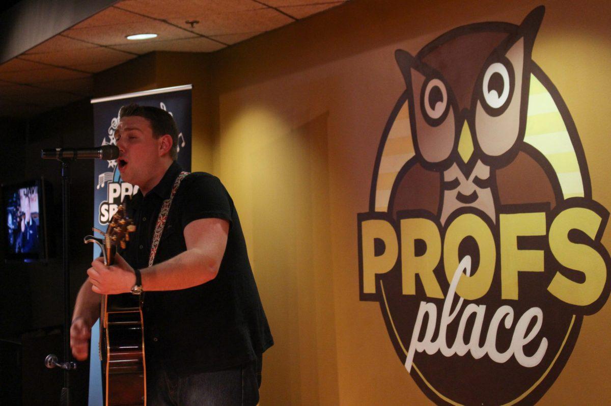 Senior biology major Devin Dromgoole performing on stage at Profs Spotlight. His set consisted of various covers and original pieces, with the covers stemming from the Killers to Bruce Springsteen. Arts & Entertainment Editor/Dylan Maslowski