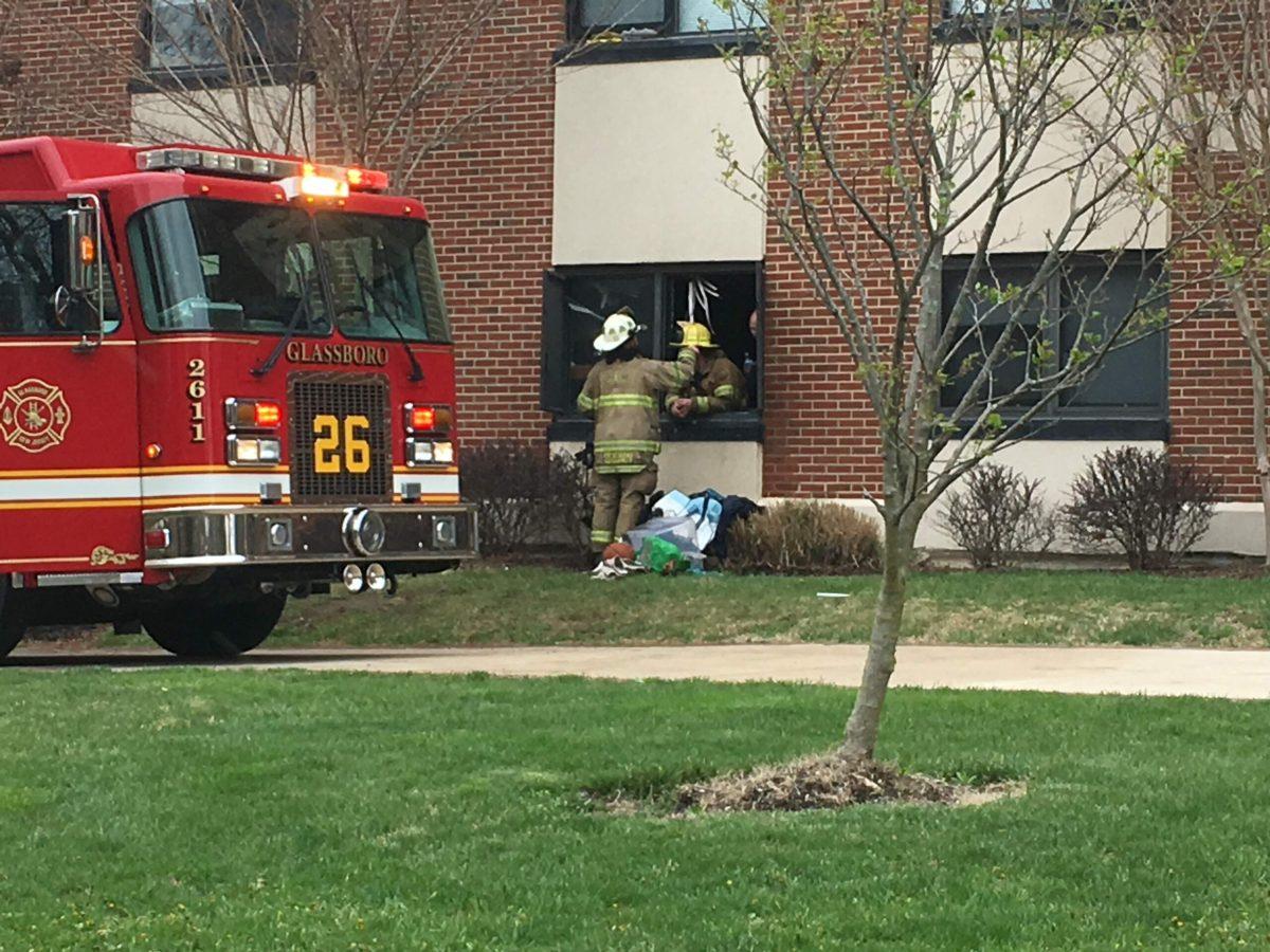 Firemen seen removing damaged personal items from a dorm in Mimosa Hall. -Staff Photo/Matt Kass