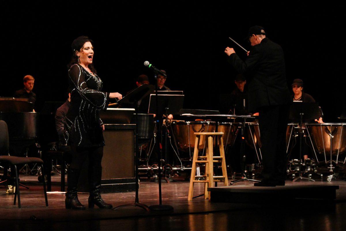 Danielle Pastin sings with the Percussion Ensemble under the direction of Dean Witten. This six part song closed out the concert. -Photo Editor/Amanda Palma