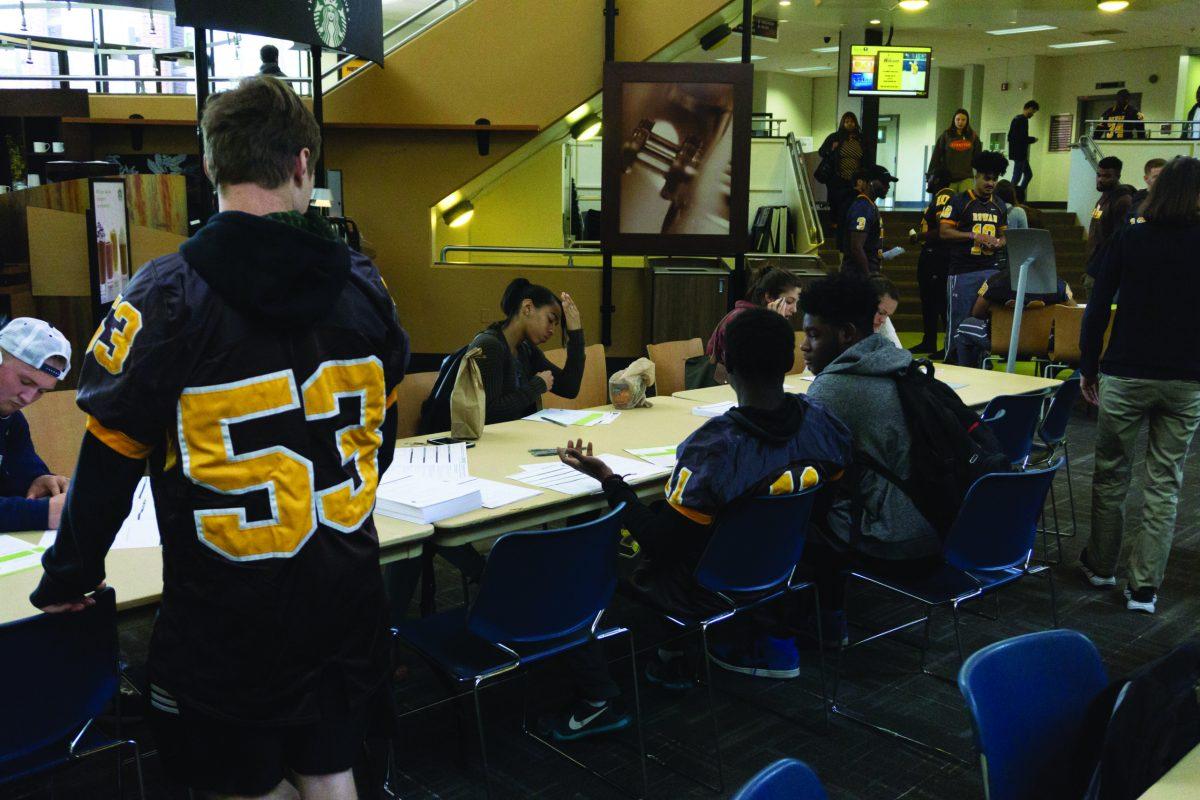 Students fill out consent forms to register as donors for, "Be the Match" bone marrow drive -Photo Editor/Cole Ditzel