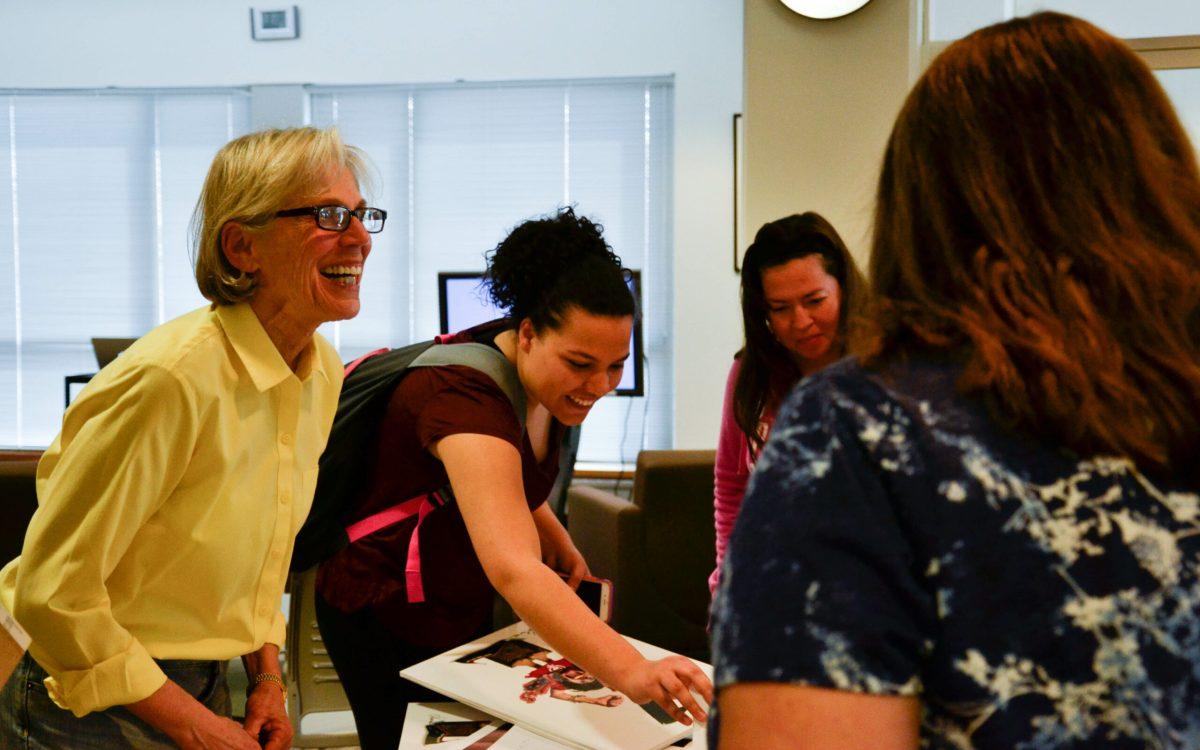 Professor Nancy Ohanian (left) gives out copies of her artwork. -Photo Editor/Nicole Mingo