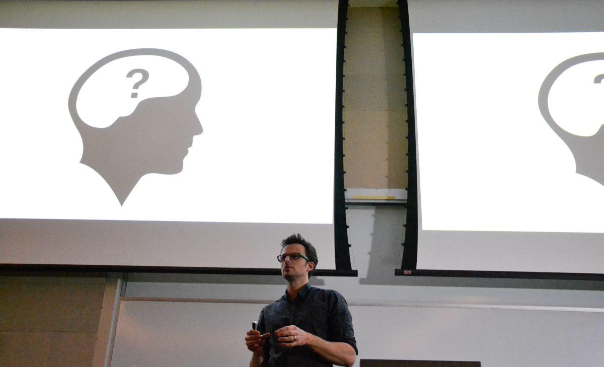 Artist Greg Dunn discussing his artwork at an event held in the Rowan Hall Auditorium. He uses neuroscience as a basis for his art. Staff Photo/Nicole Mingo