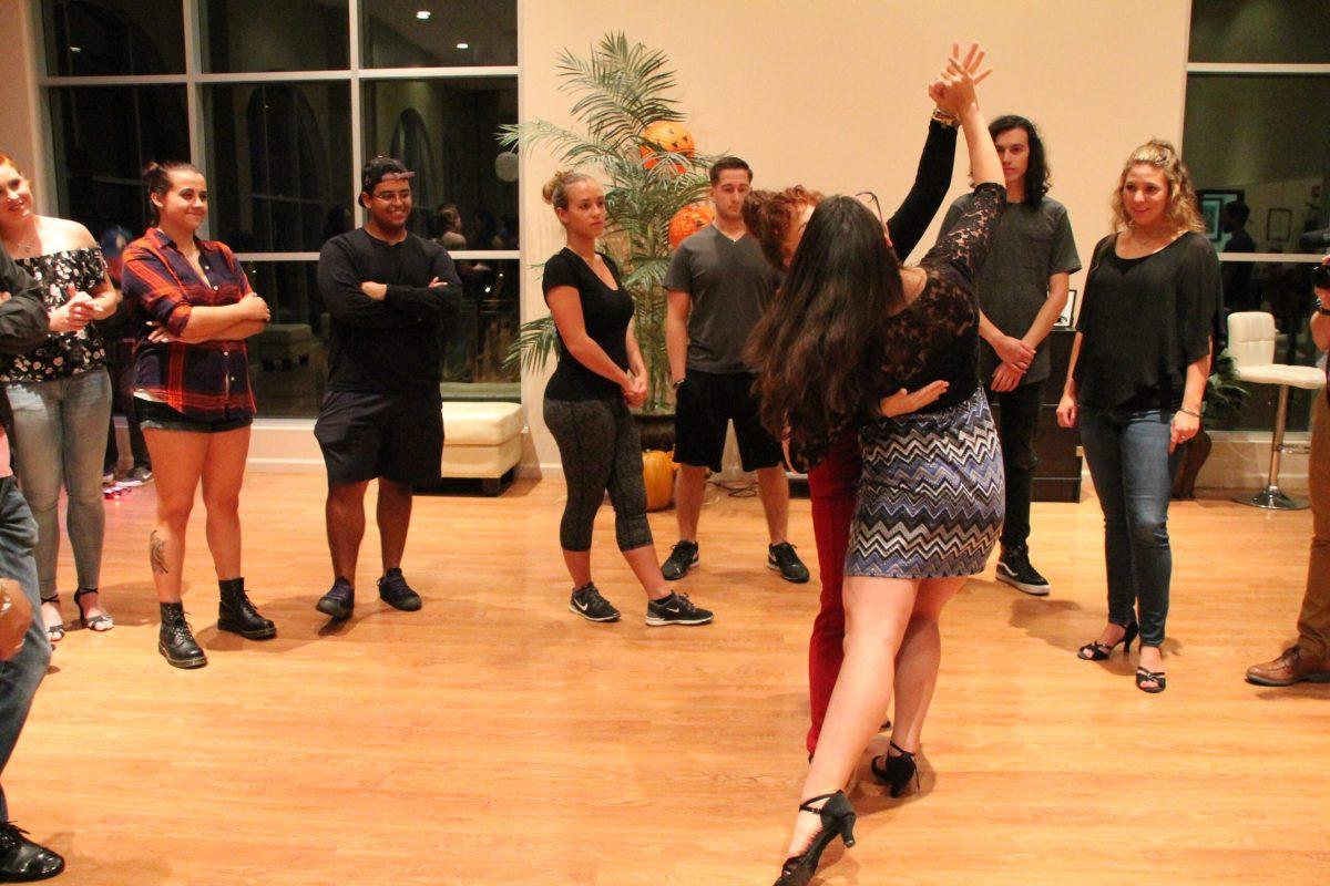 President of the Ballroom dance club, Krystal Bradley demonstrates the dos and don'ts of dancing tango and cha-cha. - Staff Photo/ Maria Morales