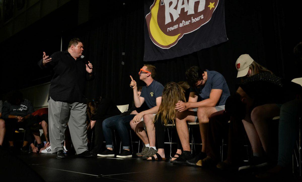 Hypnotist Dan Lornitis interacts with freshman Kevin McCarthy, who was hypnotized into becoming the "laugh police."- Photo Editor/Nicole Mingo 