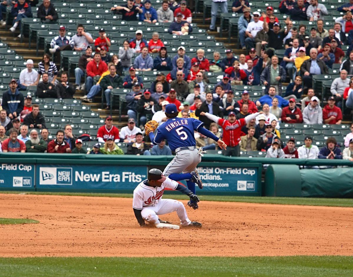 Cleveland Indians baserunner avoiding a tag from former-Texas Ranger Ian Kinsler. Photo courtesy of Pixabay user "avdaughe"