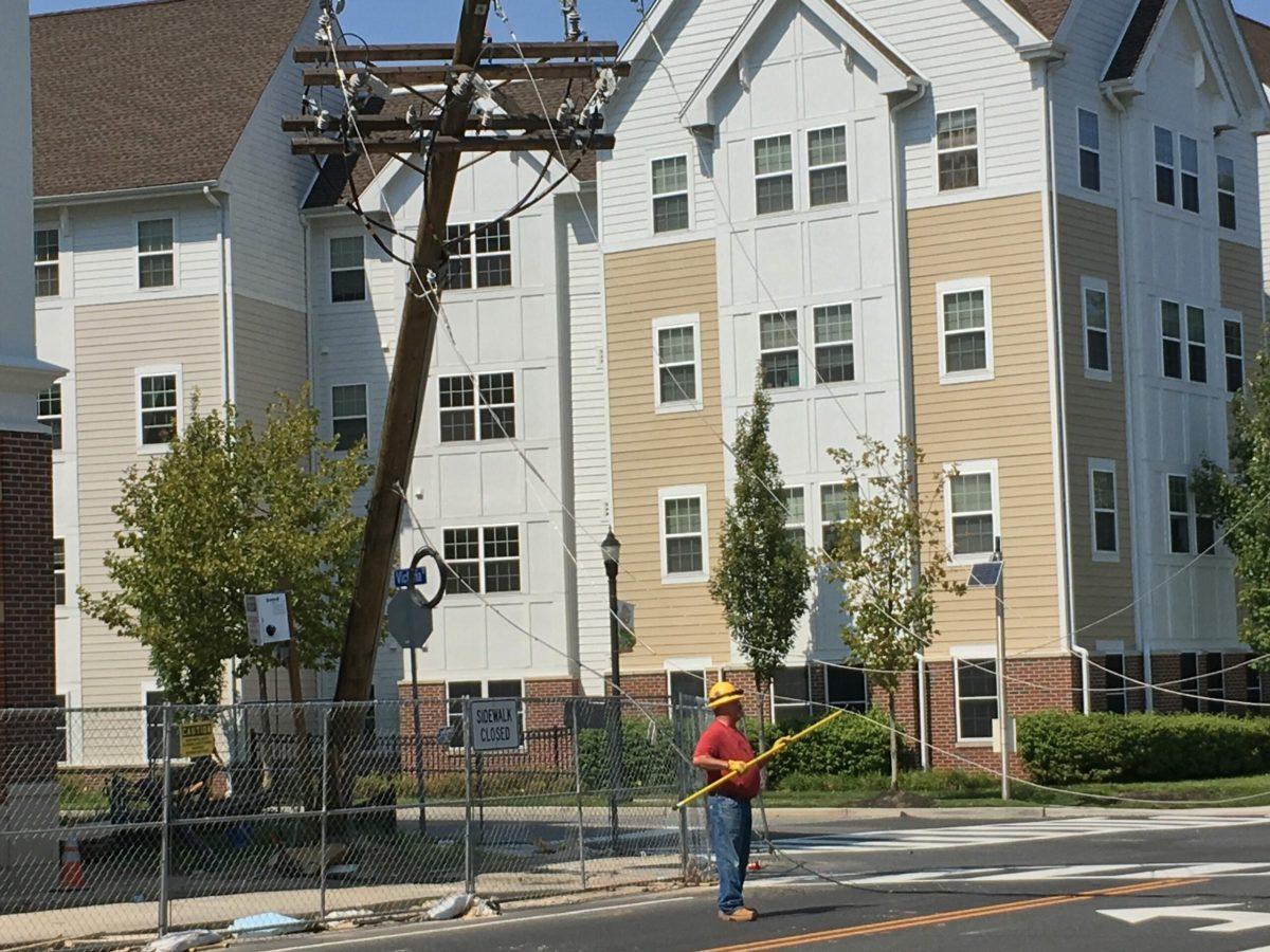 A repairman tends to a downed pole near the Rowan Boulevard Apartments.-Staff Photo/Matt Kass