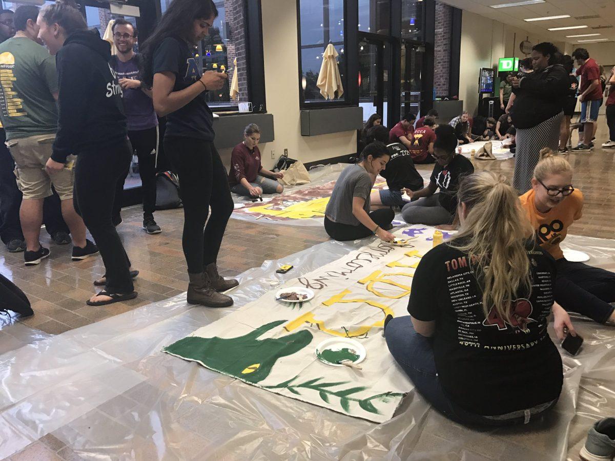 Students painting banners in the student center for  Homecoming "PROFhistoric" 2017. -Staff Photo/Sarah Jane Massaud.