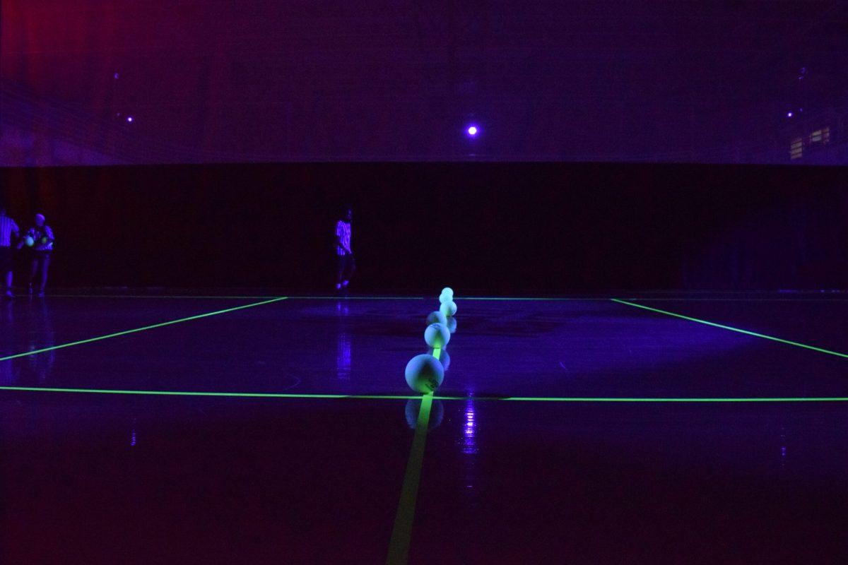 Glowing balls line the court as a game of Blacklight Dodgeball is about to begin. -Staff Photo/Andrew Turco