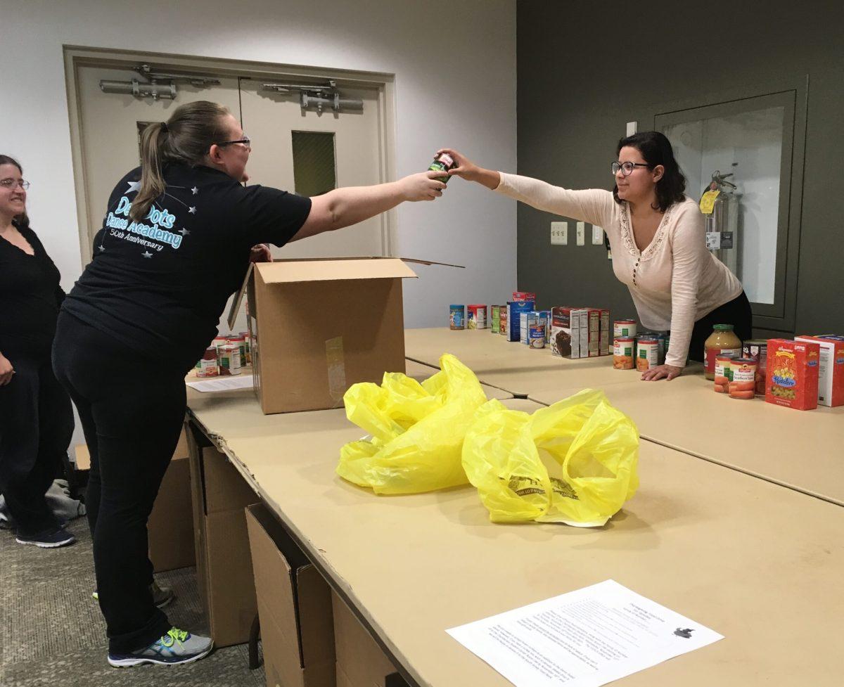 Student volunteers Mariana Cardenas (right) and Harley Buechler package supplies for the Office of Volunteerism. -News Editor/Matt Kass