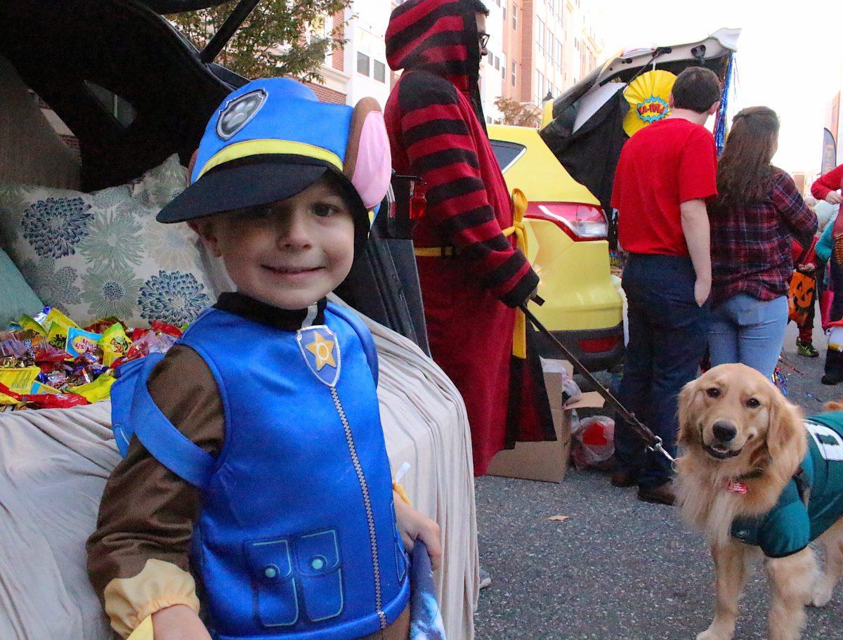 Jason Massa, 5, of Deptford, smiles after adding to his Halloween candy haul at Glassboro’s Second Annual Fall Festival and Trunk-or-Treat. The event drew hundreds of treat-seeking tikes and parents from Glassboro and surrounding towns to Rowan Boulevard Oct. 31. - Staff Photo/Taylor Henry
