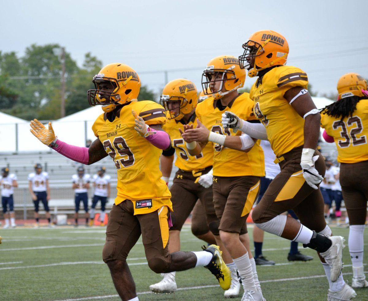 The Rowan football team prepares for a game as they run on the field two weeks ago against The College of New Jersey. Photo Editor/Nicole Mingo