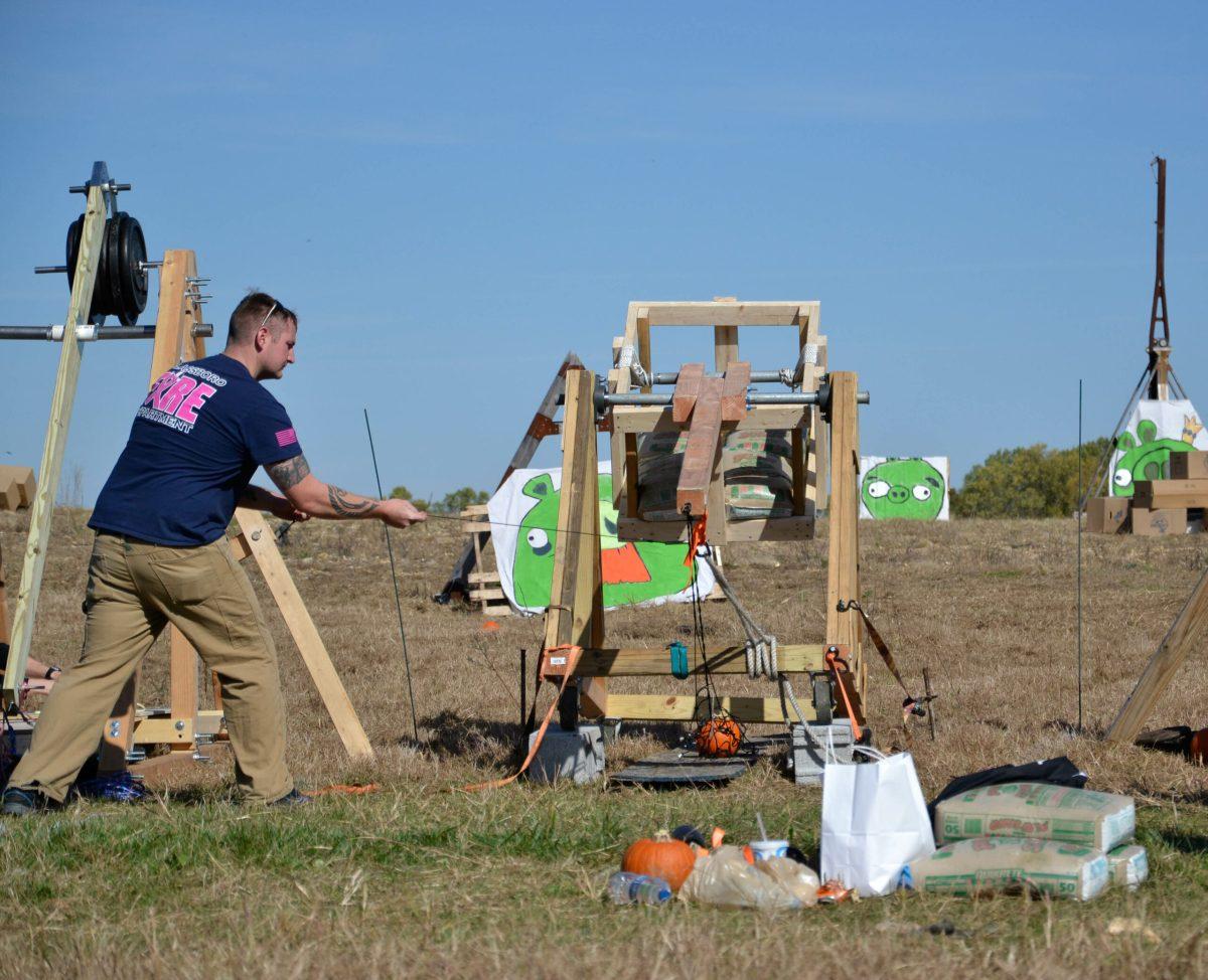 A member from the Glassboro fire department launches a pumpkin onto the field from his trebuchet. -Photo Editor/Nicole Mingo