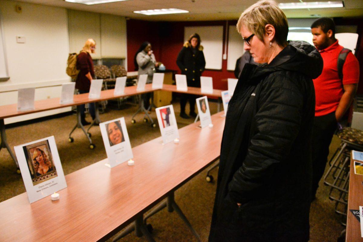 Anne Villinski observes placards on the table during the transgneder vigil on November 20, 2017. -Photo Editor/Nicole Mingo