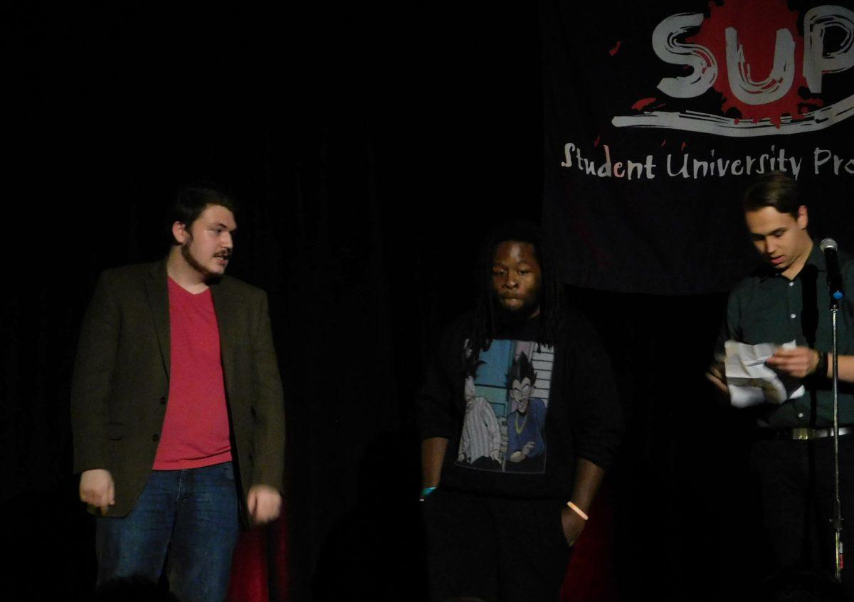 Host Evan Newlin (right) announces Sean O'Malley (left) as second place and Elijah Brown (center) as the winner. -Staff Photo/Scott Buzby 