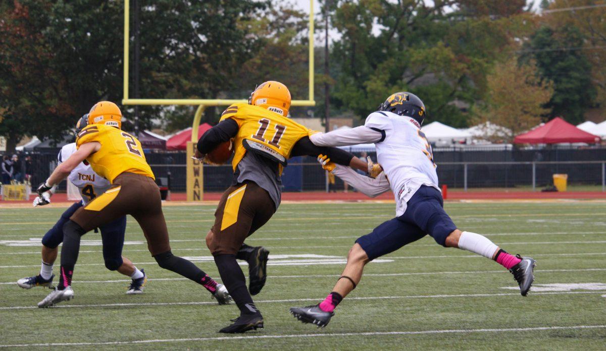 Senior wide receiver Jamel Smith goes to brush off a defender earlier this season against The College of New Jersey. Smith ended the season with 42 catches for 302 yards and two touchdowns. Photo Editor/Amanda Palma