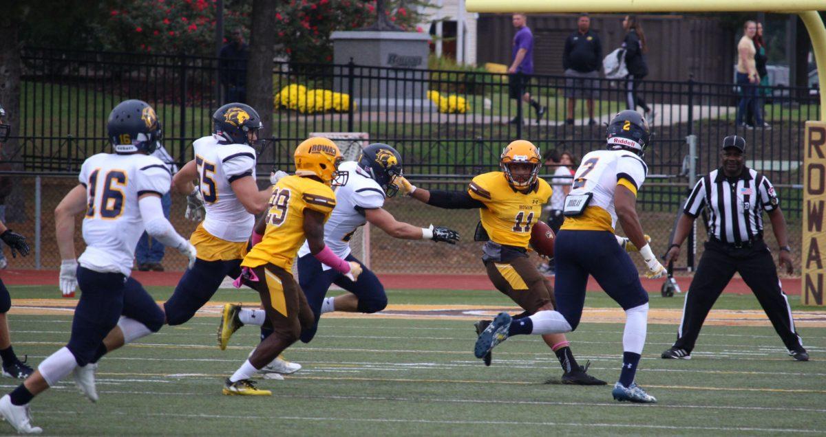 Senior wide receiver Jamel Smith looks to make a move against defenders against The College of New Jersey earlier this year. Photo Editor/Amanda Palma