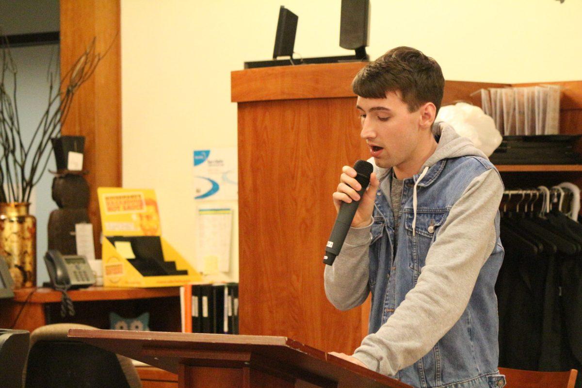 Matthew Vesely reads his poem "A Paler Shade of Green" at Avant's "Rhythm and Prose" event. -Staff Photo/Maria Morales