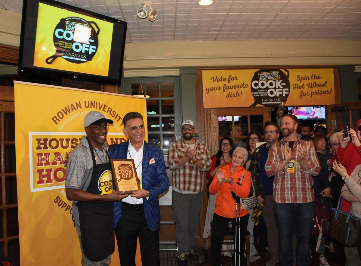 Rowan President Ali Houshmand poses with Derick "Ringo" Adamson, the winner of the hot sauce cooking competition held on Monday January 22, 2018. -Photo Editor/Nicole Mingo