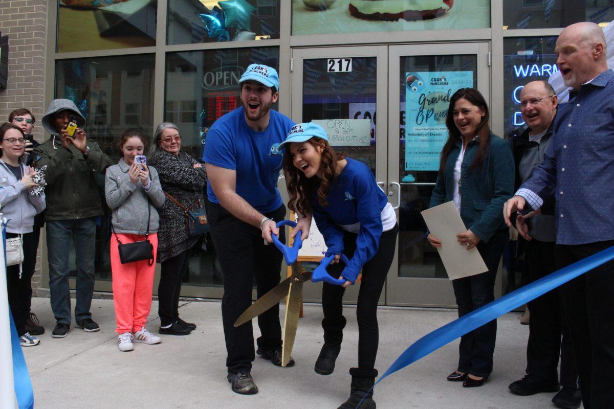 Brandon Lucante and Cassie Aran cut the ribbon officially opening their Cookie Munchers storefront on Rowan Boulevard. -Photo Editor/Amanda Palma. 