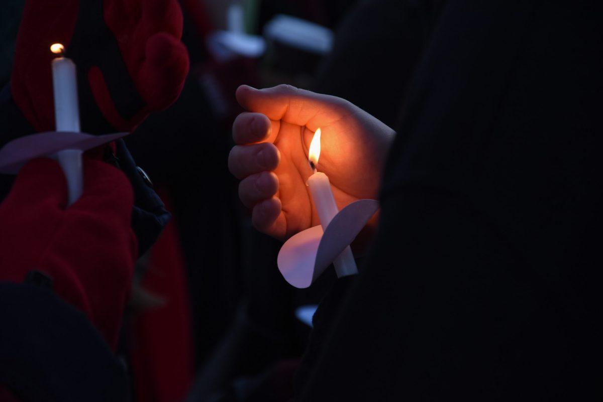 Students hold lit candles at the Holocaust Memorial service on Thursday, Jan. 25, 2017.  -Photo Editor/Nicole Mingo
