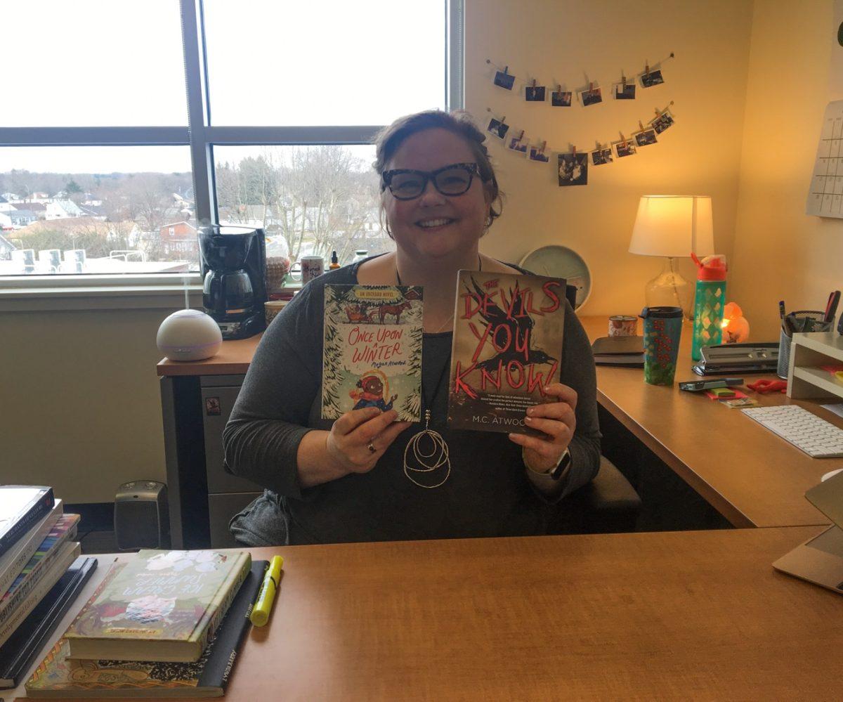 Megan Atwood poses with her novels. -Staff Photo/Grace Clevenger