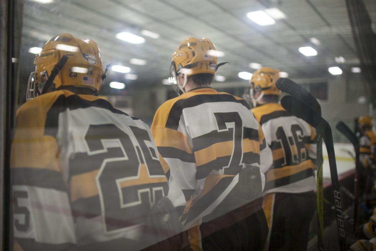 (From left to right) Christopher McDermott, Anthony Steffe and Frank Steffe look onto the ice before a game this past weekend. Assistant Photo Editor/Miguel Martinez