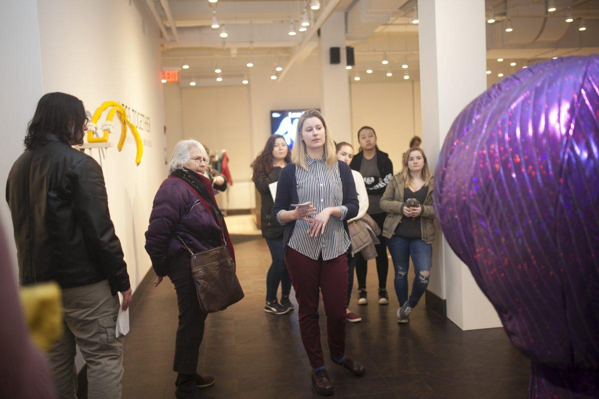 Artist in residence Sidney Mullis leads a tour of the gallery during the artist talk event on Feb. 8. -Assistant Photo Editor/Miguel Martinez