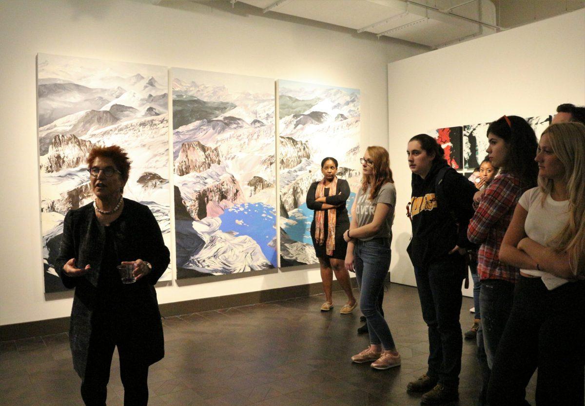 Diane Burko speaks about her creative process during her "Vast and Vanishing" opening reception on Thursday, March 8 at the Rowan Art Gallery. -Staff Photo/Maria Morales