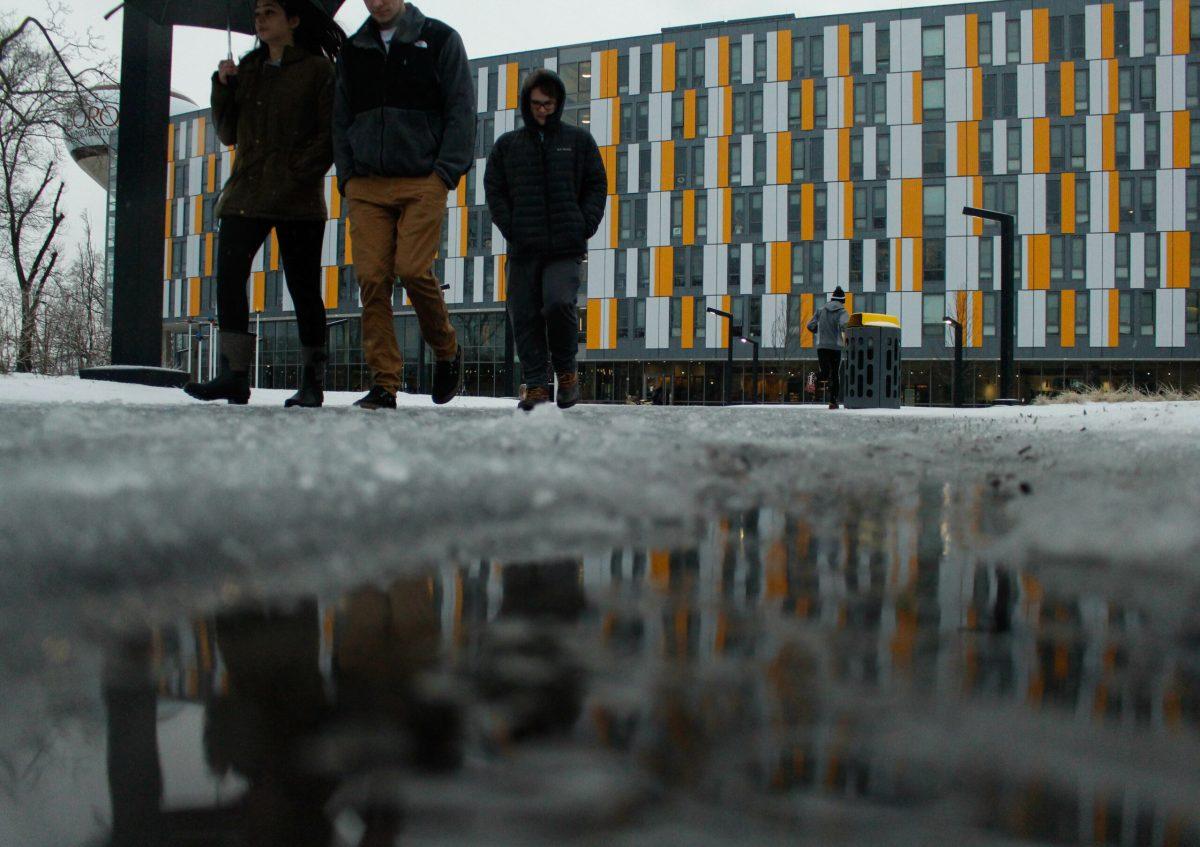 Three students walk back from Glassworks Café during the Nor'Easter Yesterday. - Staff Photo / Justin Decker