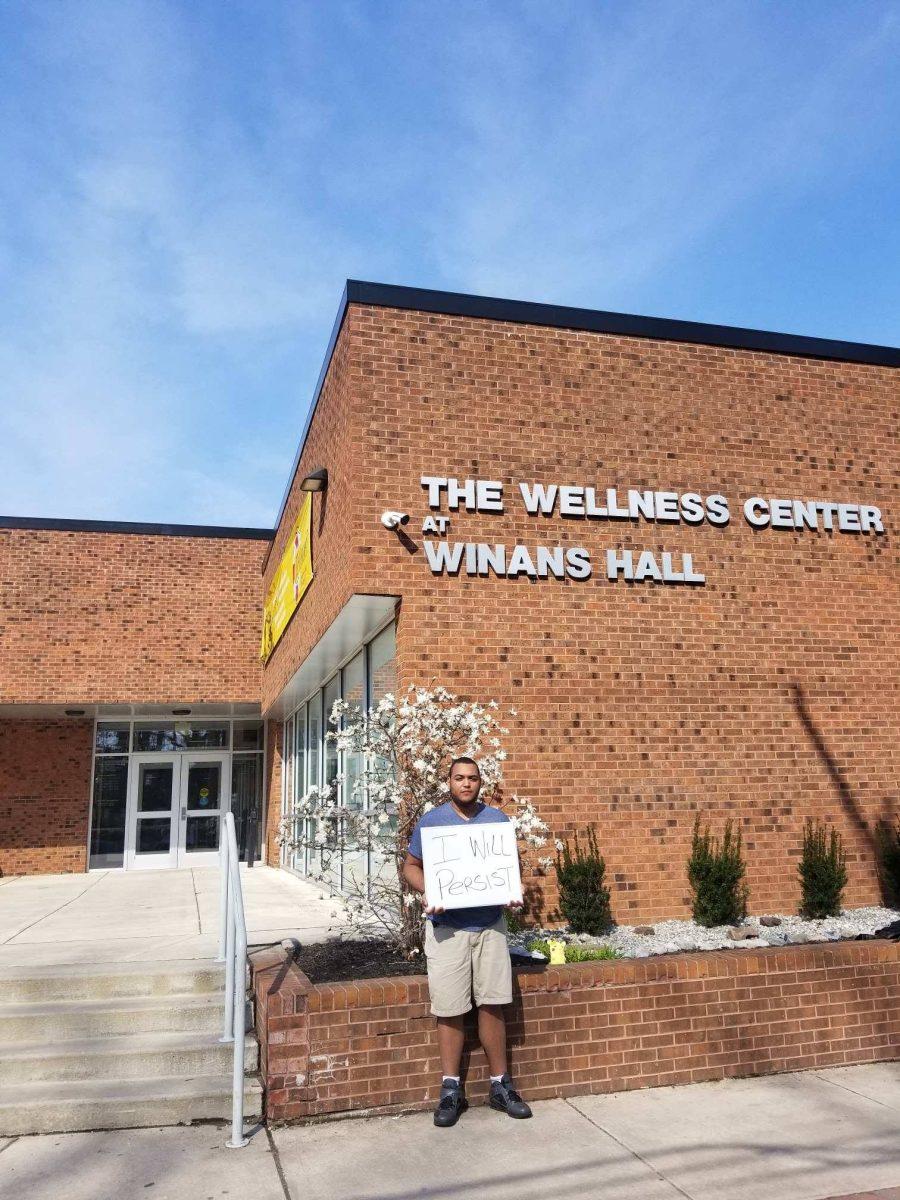 Junior history and international studies major Rayner Abreu stands in front of the Wellness Center for the RU OKAY Project. -Photo courtesy of Austin O'Neill