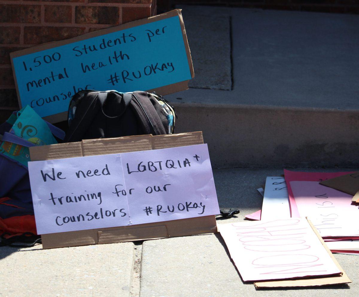 Signs lay on the ground outside of the Student Center Patio in protest of the new proposed copay for the Wellness Center, on Monday April 23, 2018. -File Photo / Jaryd Leady