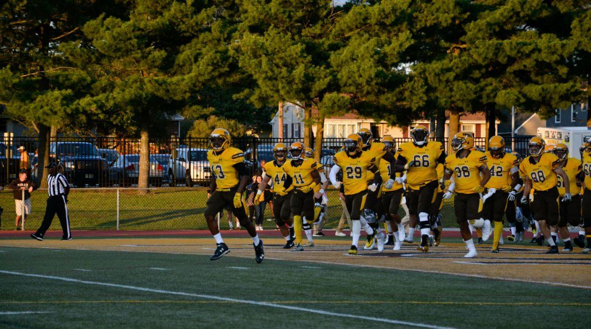 Senior defensive back and captain Travelle Curry leads the Profs onto the turf last year against Southern Virginia University. Photo courtesy of Nicole Mingo. 