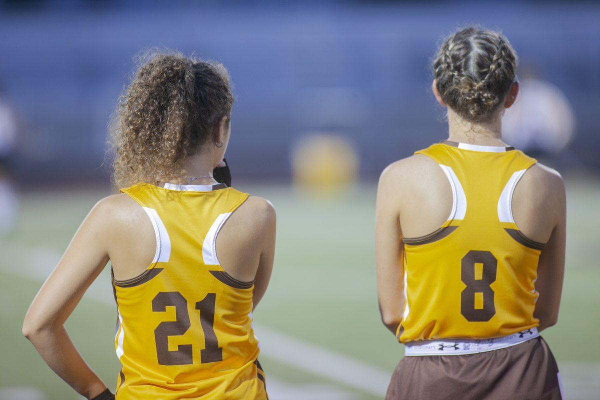 Jen Dean and 21 Celia Sokolofski look onto the field. Multimedia Editor/Miguel Martinez