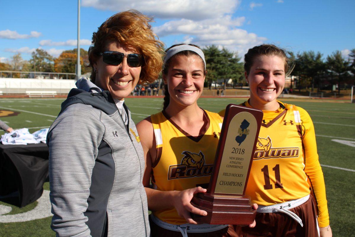 Rowan head coach Michelle Andre, Skylar Pino and Julie Johnson take a picture with the NJAC trophy after Rowan's 2-0 win in the title game over TCNJ. Photo courtesy of Rowan Athletics. 