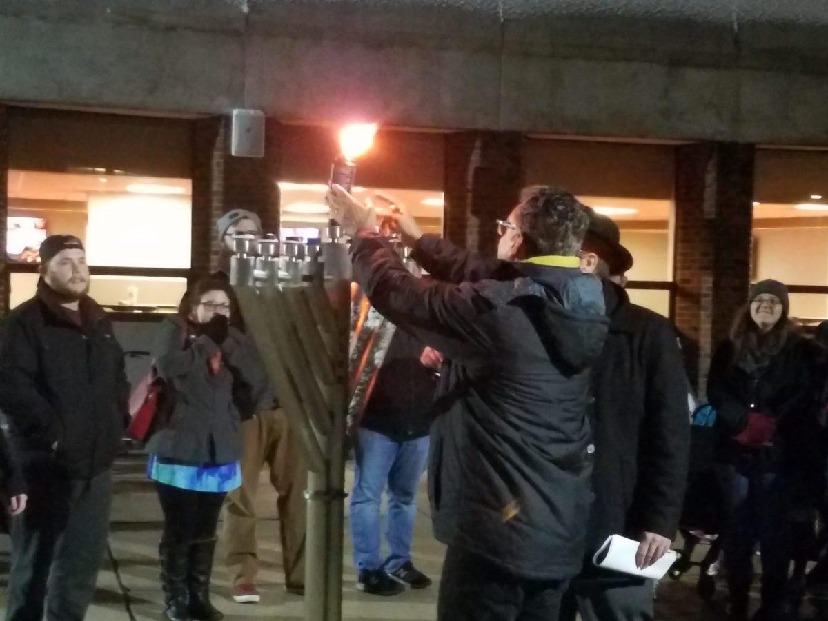 Students from the Jewish community gather outside the student center to light the menorah in celebration of Hanukkah. - File photo / Alex Heller