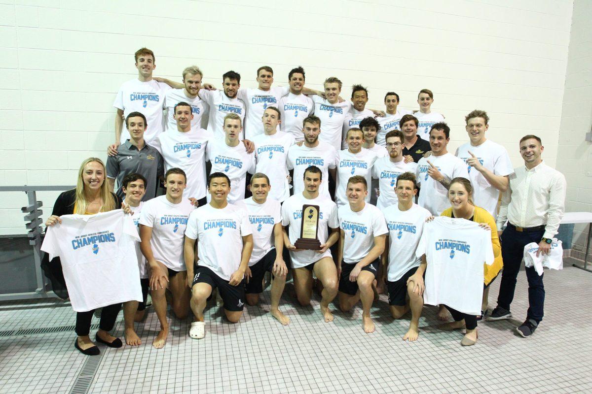 The men's swimming and diving team pose with their NJAC Champions t-shirts after sweeping the conference 4-0 for  the third consecutive year. Photo courtesy of Rowan Athletics.