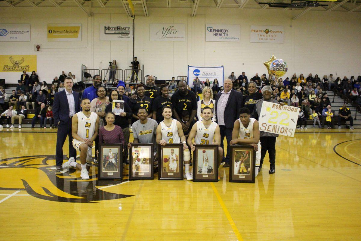 DaRon Curry, Teirique Robinson, Ramon Wright, Rob and Nick Depersia take a photo with head coach Joe Crispin, family and friends during their Senior Night on Saturday. Photo courtesy of Rowan Athletics