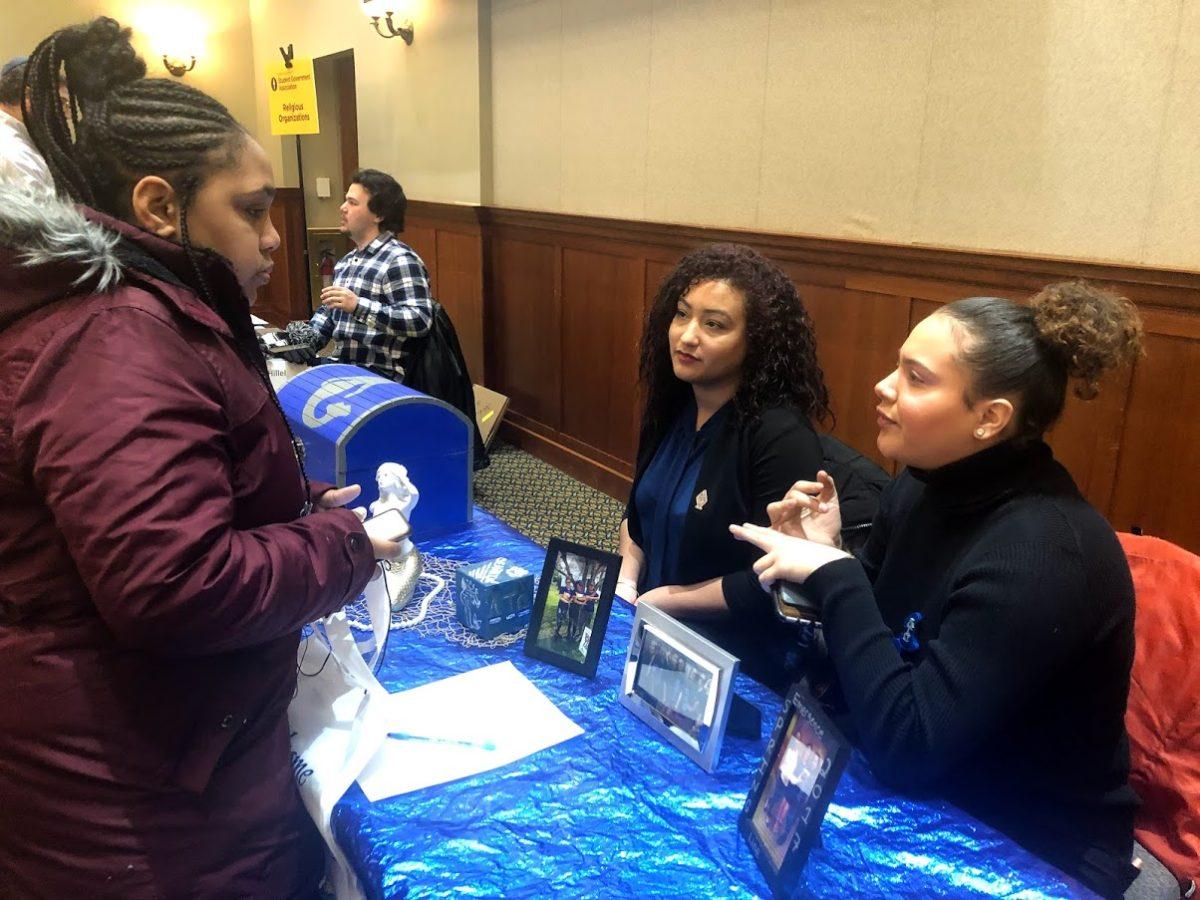 (L to R) Kariyah Bennett (junior radio, television and film major), Kimberly Diaz (sophomore english major) and Neashally Luna (junior criminal justice and political science major) at their table, Lambda Tau Omega Sorority, Inc. -Photo courtesy of Kalie VanDewater