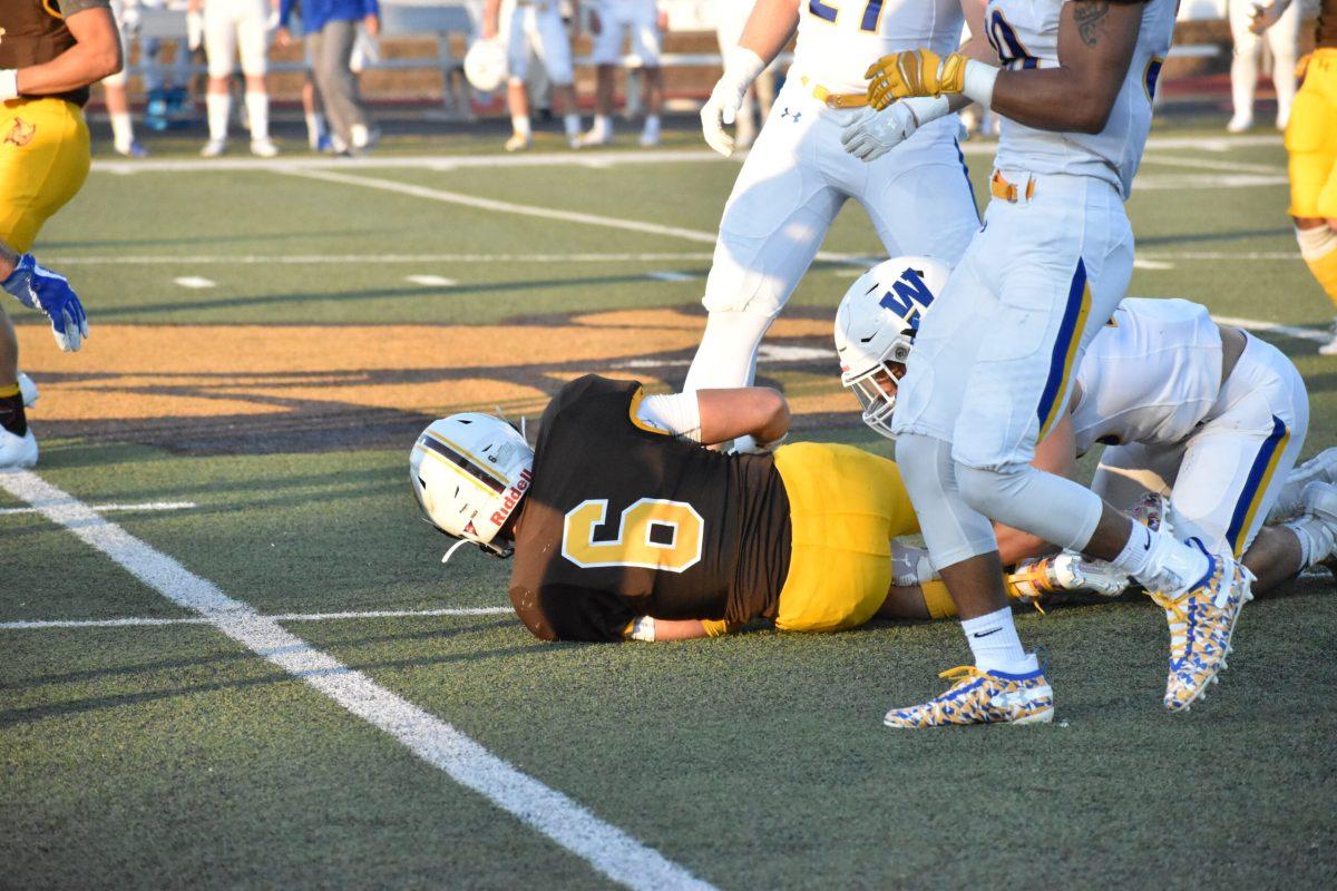 Elijah Rehm tackled in game one against Widener. - Multimedia Editor / Christian A Browne