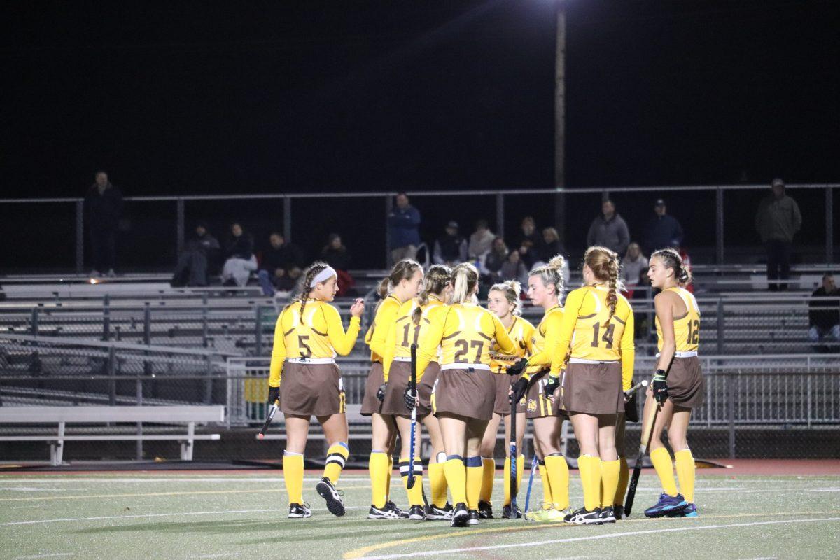 The field hockey team huddles in a game last season. Photo / Multimedia Editor Dyone Payne